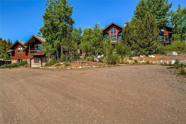 348 Jade Rd, Silverthorne, CO 80498 - view of front facade with a garage, dirt driveway, and a balcony