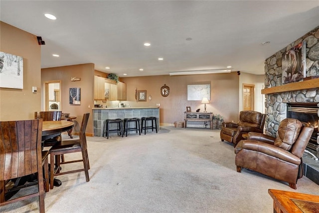 348 Jade Rd, Silverthorne, CO 80498 - living area featuring light carpet, recessed lighting, baseboards, and a stone fireplace