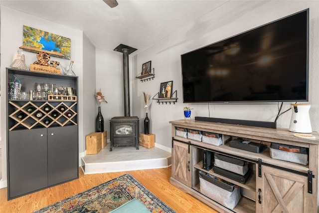 26 Cypress Ct Unit 26, Steamboat Springs, CO 80487 - living room featuring light wood-type flooring, baseboards, and a wood stove