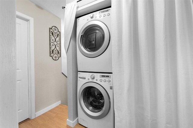 26 Cypress Ct Unit 26, Steamboat Springs, CO 80487 - washroom with stacked washer / drying machine, light wood finished floors, baseboards, and laundry area