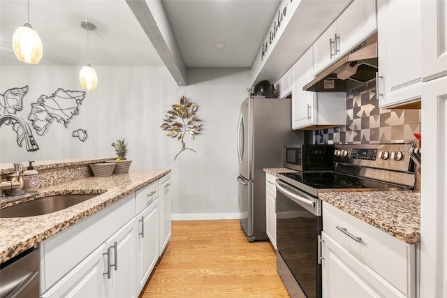 26 Cypress Ct Unit 26, Steamboat Springs, CO 80487 - kitchen with white cabinets, stainless steel appliances, under cabinet range hood, and a sink