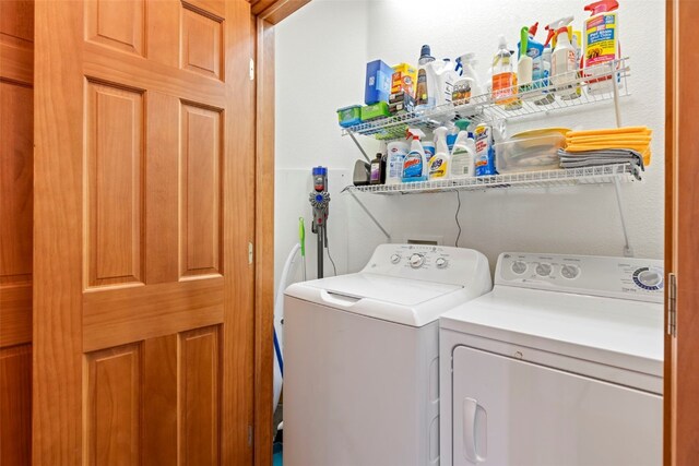 clothes washing area with separate washer and dryer and laundry area