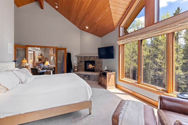 bedroom with high vaulted ceiling, wooden ceiling, a stone fireplace, and carpet
