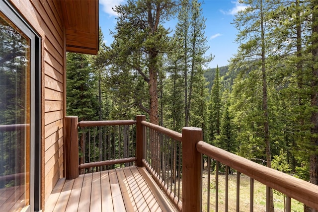 wooden terrace with a view of trees