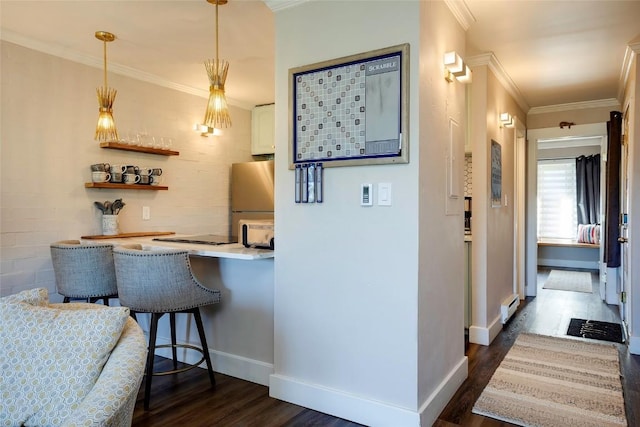 1920 Ski Time Square Dr Unit 402, Steamboat Springs, CO 80487 - bar area featuring freestanding refrigerator, dark wood finished floors, a baseboard heating unit, ornamental molding, and decorative light fixtures