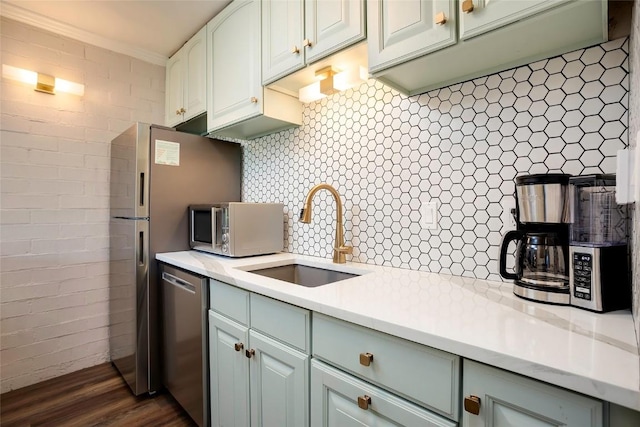 1920 Ski Time Square Dr Unit 402, Steamboat Springs, CO 80487 - kitchen with stainless steel appliances, a sink, dark wood-type flooring, light countertops, and crown molding