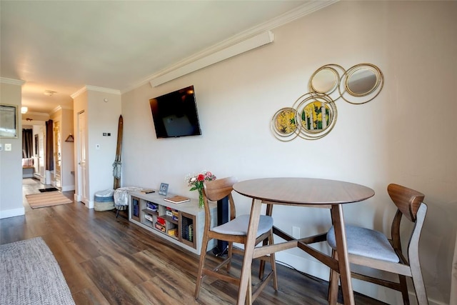 1920 Ski Time Square Dr Unit 402, Steamboat Springs, CO 80487 - dining area with crown molding, wood finished floors, and baseboards