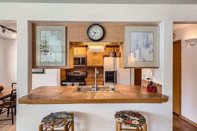 14 Crystal Cv Unit C14, Dillon, CO 80435 - kitchen featuring stainless steel microwave, electric range, white refrigerator with ice dispenser, a peninsula, and track lighting