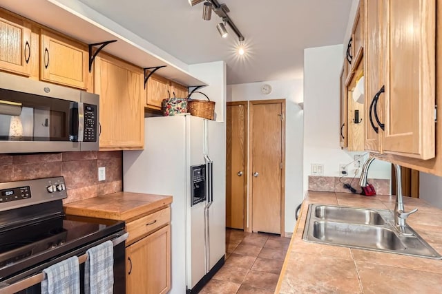 14 Crystal Cv Unit C14, Dillon, CO 80435 - kitchen with stainless steel appliances, light brown cabinets, decorative backsplash, light tile patterned floors, and rail lighting