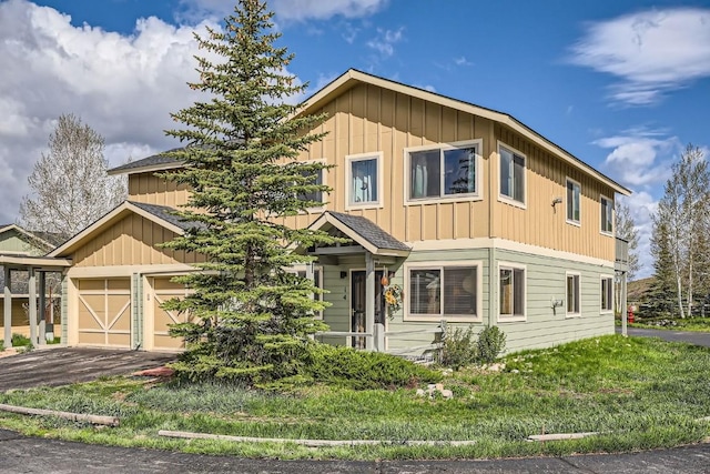 14 Crystal Cv Unit C14, Dillon, CO 80435 - view of front of home featuring board and batten siding, a garage, and a front lawn