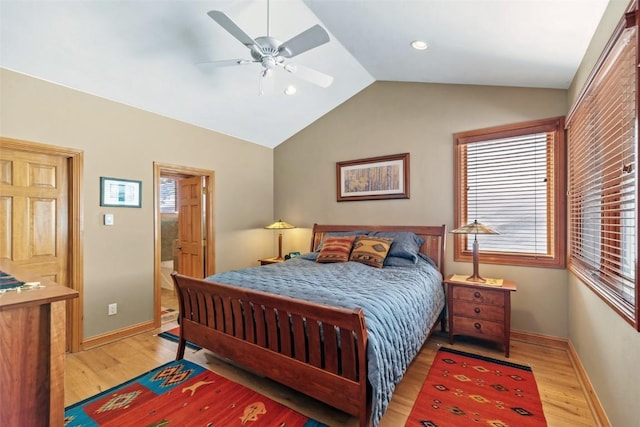 bedroom featuring light wood-style floors, vaulted ceiling, baseboards, and ceiling fan