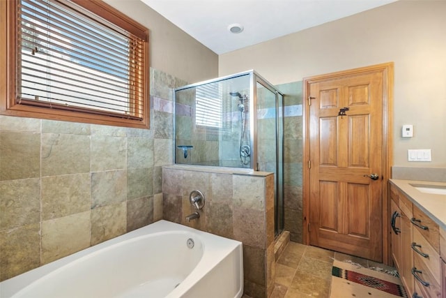full bathroom featuring a garden tub, vanity, and a stall shower