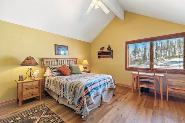 bedroom featuring light wood-style flooring, vaulted ceiling with beams, baseboards, and ceiling fan