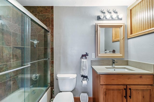 full bathroom with vanity, shower / bath combination with glass door, and toilet