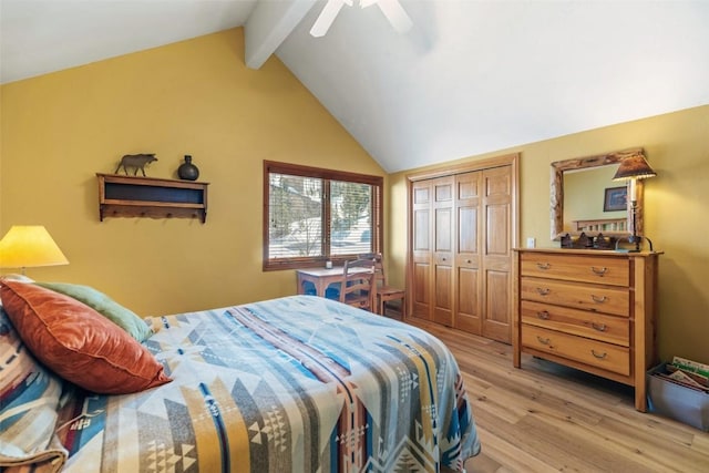 bedroom with light wood-style flooring, a closet, vaulted ceiling with beams, and a ceiling fan