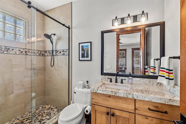 full bath featuring a shower stall, toilet, and vanity