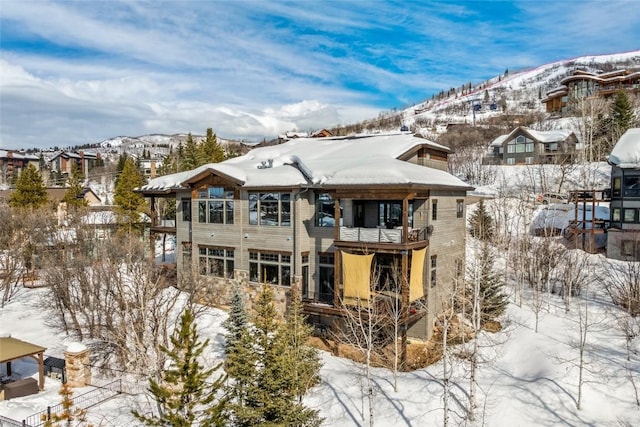 snow covered property featuring a mountain view