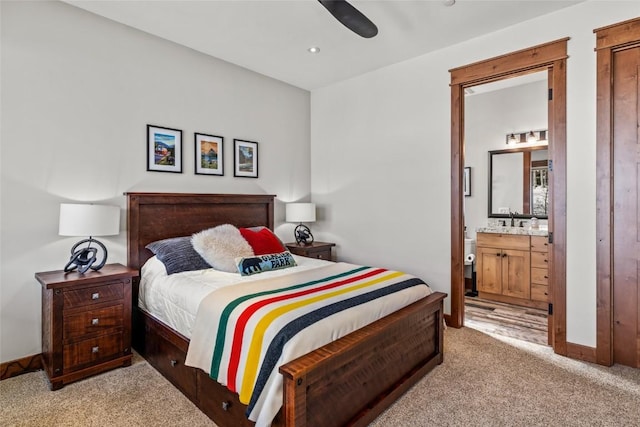 bedroom with a sink, carpet, baseboards, and connected bathroom