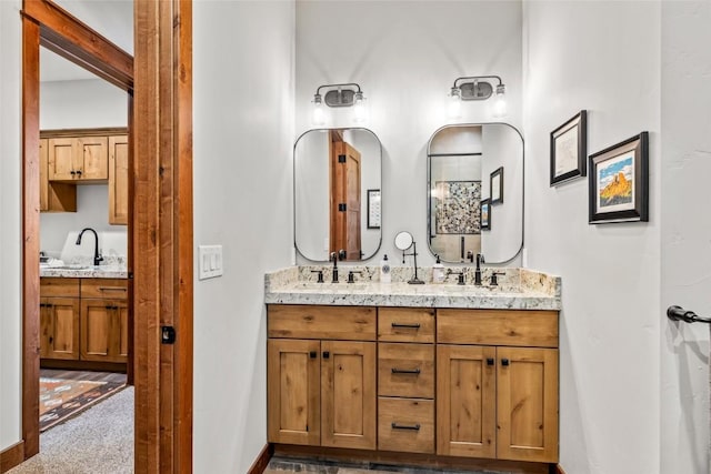 bathroom featuring a sink, baseboards, and double vanity