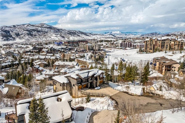 snowy aerial view with a mountain view