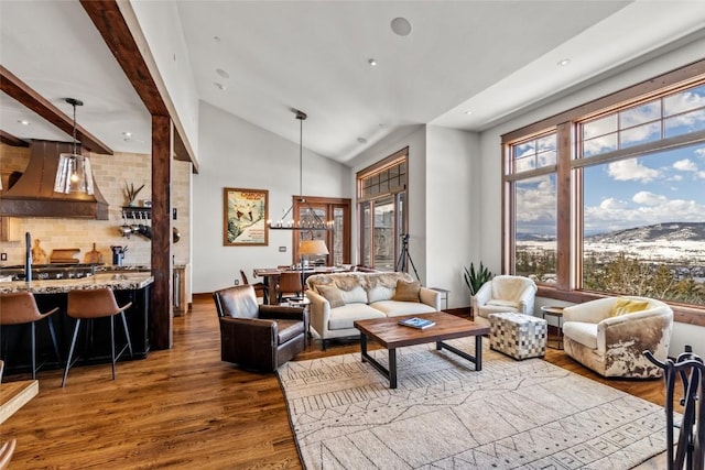 living room featuring high vaulted ceiling, wood finished floors, and recessed lighting