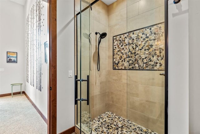 full bath featuring a stall shower and baseboards