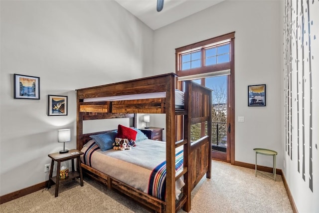 bedroom featuring access to outside, multiple windows, baseboards, and light colored carpet