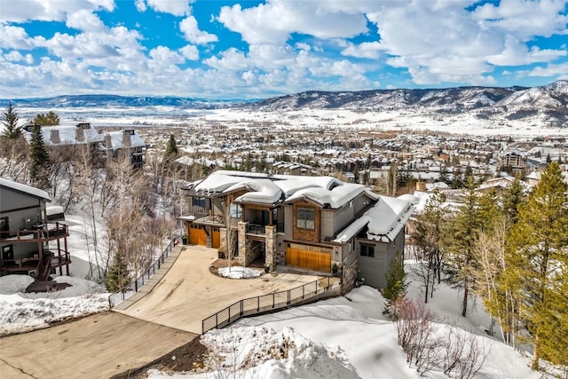 view of front facade with fence, a mountain view, and a residential view