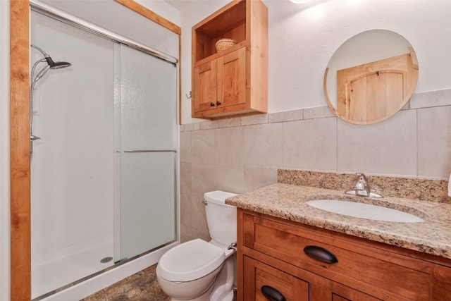 126 E 1st St, Oak Creek, CO 80467 - full bath with vanity, a stall shower, tile walls, toilet, and a wainscoted wall