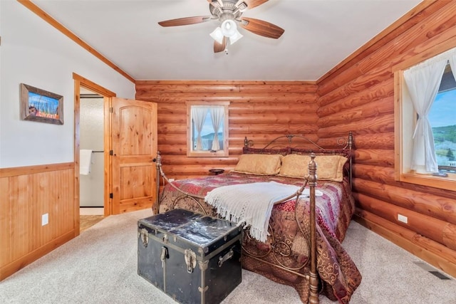 126 E 1st St, Oak Creek, CO 80467 - bedroom with a wainscoted wall, log walls, carpet, and a ceiling fan