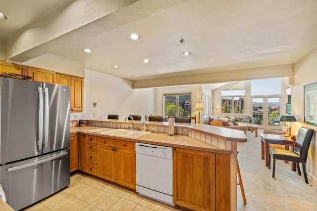 1724 Ski Time Square Dr Unit R5, Steamboat Springs, CO 80487 - kitchen featuring freestanding refrigerator, white dishwasher, a sink, a peninsula, and recessed lighting