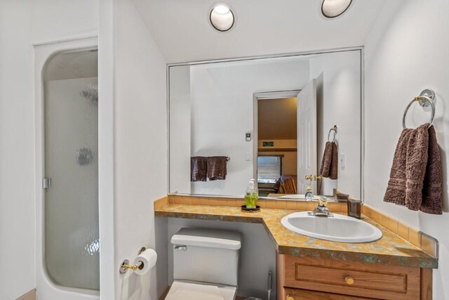 1724 Ski Time Square Dr Unit R5, Steamboat Springs, CO 80487 - bathroom featuring a stall shower, toilet, vanity, and ensuite bath