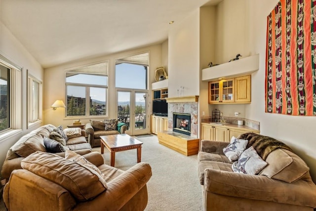1724 Ski Time Square Dr Unit R5, Steamboat Springs, CO 80487 - living room with light carpet, a high end fireplace, plenty of natural light, and high vaulted ceiling