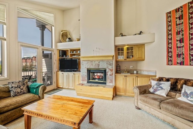1724 Ski Time Square Dr Unit R5, Steamboat Springs, CO 80487 - living room featuring light carpet, a premium fireplace, and a towering ceiling