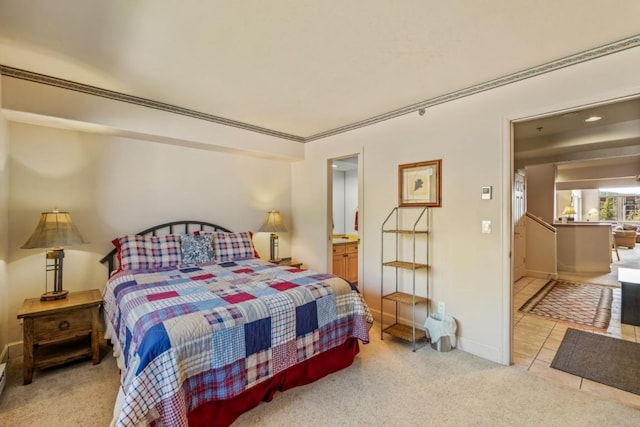1724 Ski Time Square Dr Unit R5, Steamboat Springs, CO 80487 - bedroom featuring ensuite bath, light colored carpet, baseboards, and light tile patterned floors