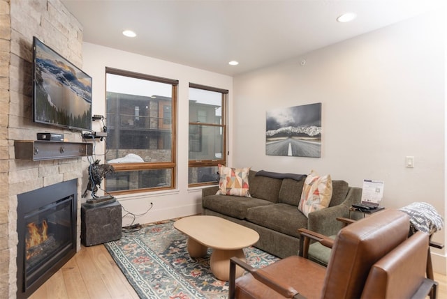 1080 Blue River Pkwy Unit 203, Silverthorne, CO 80498 - living area featuring baseboards, a large fireplace, wood finished floors, and recessed lighting
