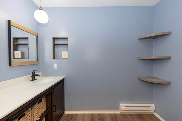 6950 Ryan Gulch Rd Unit 6950, Silverthorne, CO 80498 - bathroom with baseboard heating, wood finished floors, vanity, and baseboards