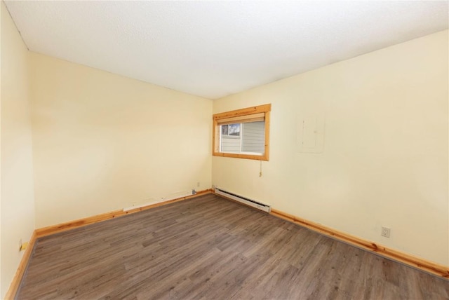 6950 Ryan Gulch Rd Unit 6950, Silverthorne, CO 80498 - unfurnished room featuring a baseboard radiator, wood finished floors, and baseboards