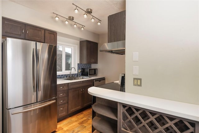 6950 Ryan Gulch Rd Unit 6950, Silverthorne, CO 80498 - kitchen featuring stainless steel appliances, under cabinet range hood, a sink, and dark brown cabinetry