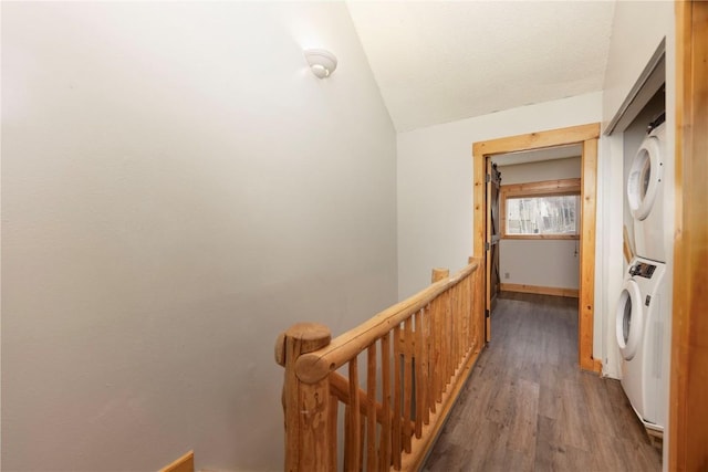 6950 Ryan Gulch Rd Unit 6950, Silverthorne, CO 80498 - hallway with stacked washer / drying machine, an upstairs landing, wood finished floors, and vaulted ceiling