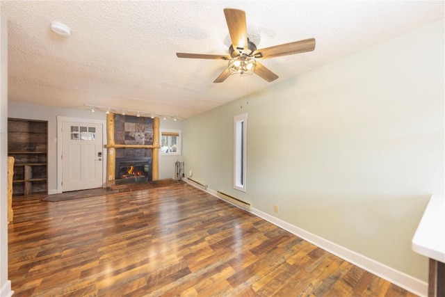 6950 Ryan Gulch Rd Unit 6950, Silverthorne, CO 80498 - unfurnished living room featuring wood finished floors, ceiling fan, a textured ceiling, a fireplace, and baseboards