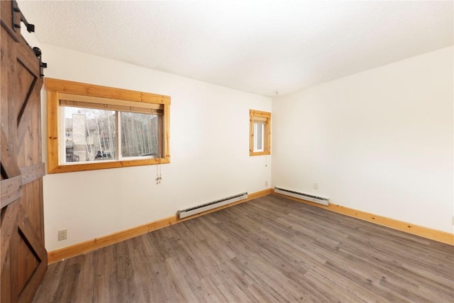6950 Ryan Gulch Rd Unit 6950, Silverthorne, CO 80498 - unfurnished room with baseboard heating, wood finished floors, and baseboards