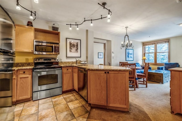 140 Ida Belle Dr Unit 8178, Keystone, CO 80435 - kitchen with track lighting, a peninsula, a chandelier, and stainless steel appliances