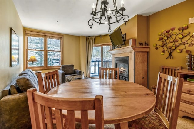 140 Ida Belle Dr Unit 8178, Keystone, CO 80435 - dining room with visible vents, a glass covered fireplace, and an inviting chandelier