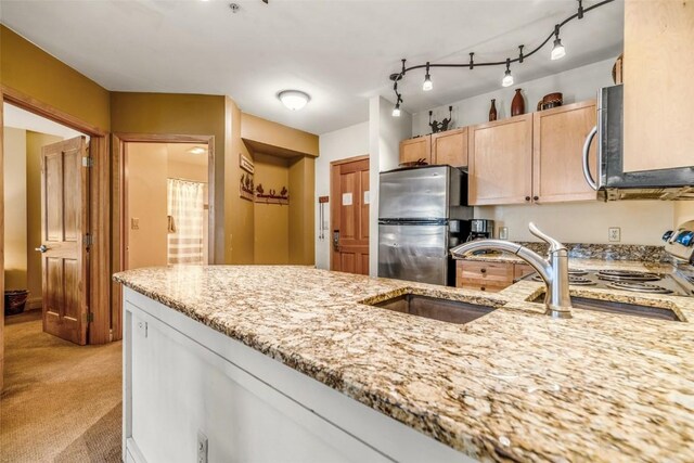 140 Ida Belle Dr Unit 8178, Keystone, CO 80435 - kitchen with light brown cabinetry, light carpet, a sink, light stone countertops, and appliances with stainless steel finishes