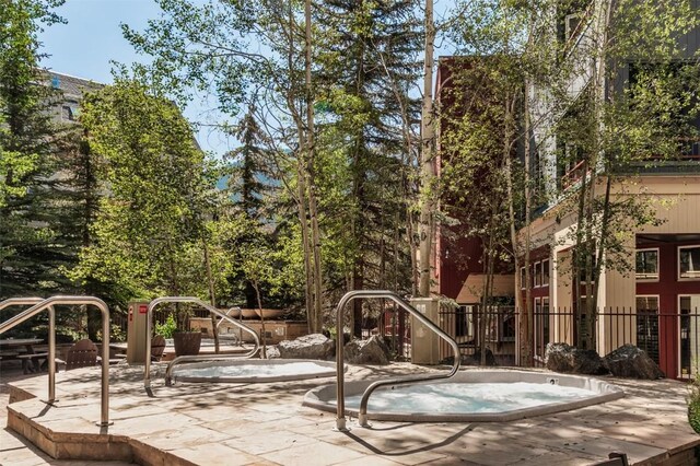 140 Ida Belle Dr Unit 8178, Keystone, CO 80435 - view of home's community featuring a hot tub, a patio, and fence