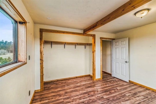 259 Falcon Rd, Como, CO 80432 - unfurnished bedroom with a closet, wood finished floors, baseboards, and beamed ceiling