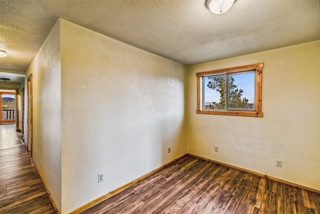 259 Falcon Rd, Como, CO 80432 - unfurnished room with dark wood-type flooring, a textured ceiling, plenty of natural light, baseboards, and a textured wall