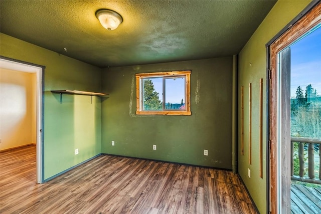 259 Falcon Rd, Como, CO 80432 - unfurnished bedroom with wood finished floors, multiple windows, a textured ceiling, and a closet