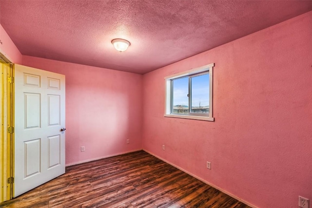259 Falcon Rd, Como, CO 80432 - spare room featuring dark wood finished floors, a textured ceiling, and baseboards